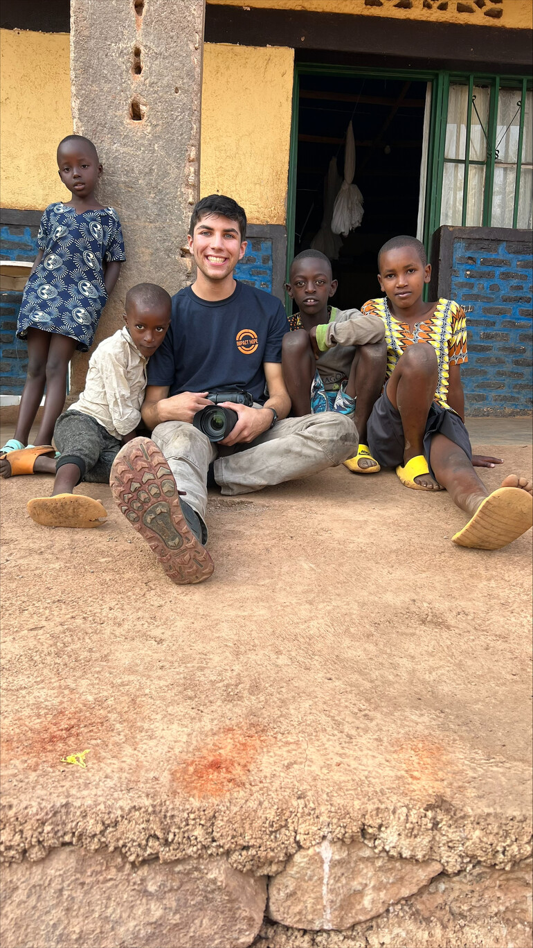 Tyler Parker visits with refugee children in Rwanda.